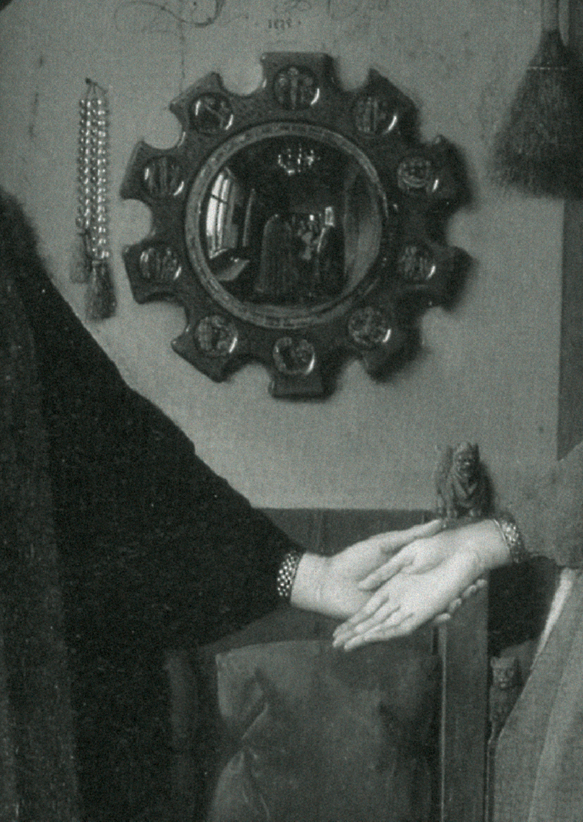 Convex mirror behind hands in Jan Van Eyck’s Arnolfini Portrait, 1434.