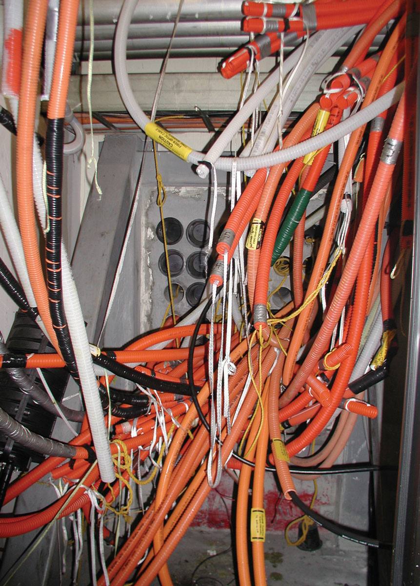 A photograph of tangled wires in an underground closet in the parking garage at One Wilshire. Fiber optic cables exit the building here, on their way across the country or across the ocean. Carriers are allowed to run interconnects directly between each other without charge on the fourth-floor “Meet-Me-Room.” The result is a dramatic cost savings for the companies that allows One Wilshire’s management to charge the highest per-square-foot rents on the North American continent.