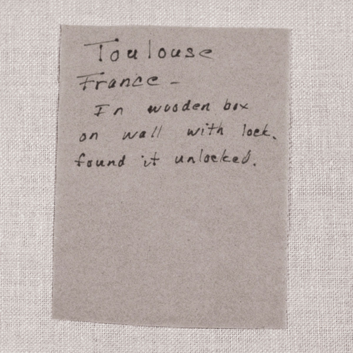 A piece of toilet paper annotated with the phrase: “Toulouse France - In wooden box on wall with lock, found it unlocked.”