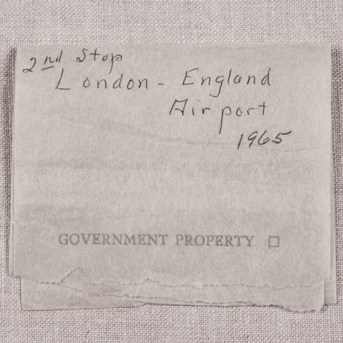 A piece of toilet paper annotated with the phrase: “2nd Stop London - England Airport 1965.”