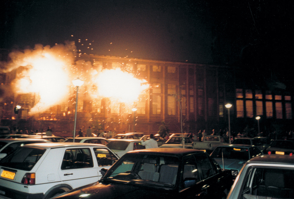  A 1995 photograph of a building burning in Johannesburg, South Africa, by artist Cai Guo-Qiang, from the series “Restrained Violence: Rainbow: Project for Extraterrestrials No. 25.”