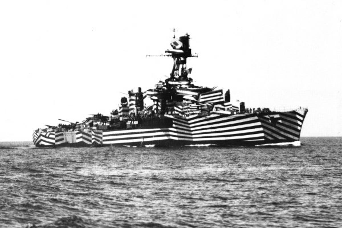 A photograph of the World War one French ship ”Gloire,” painted with camouflage stripes.