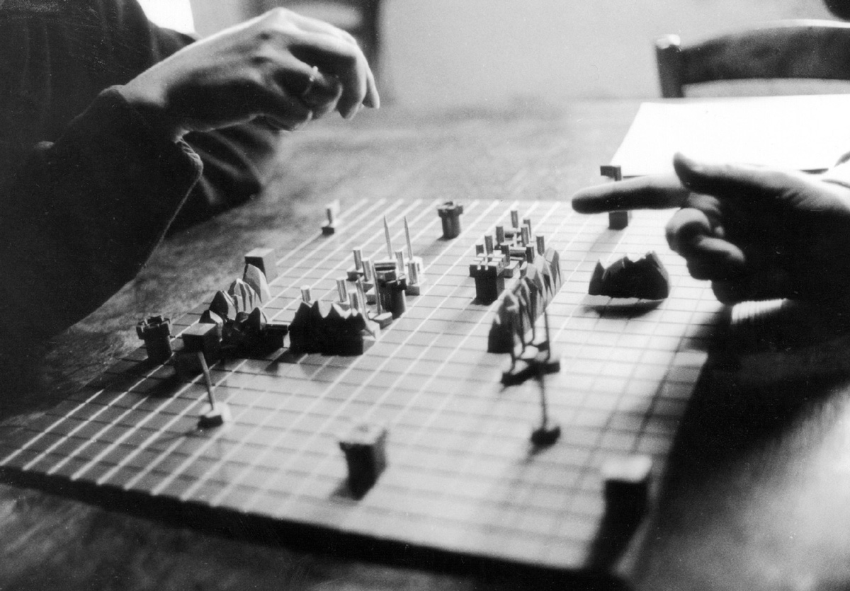 A photograph showing Guy Debord and Alice Becker-Ho playing the Game of War, nineteen seventy-seven.
