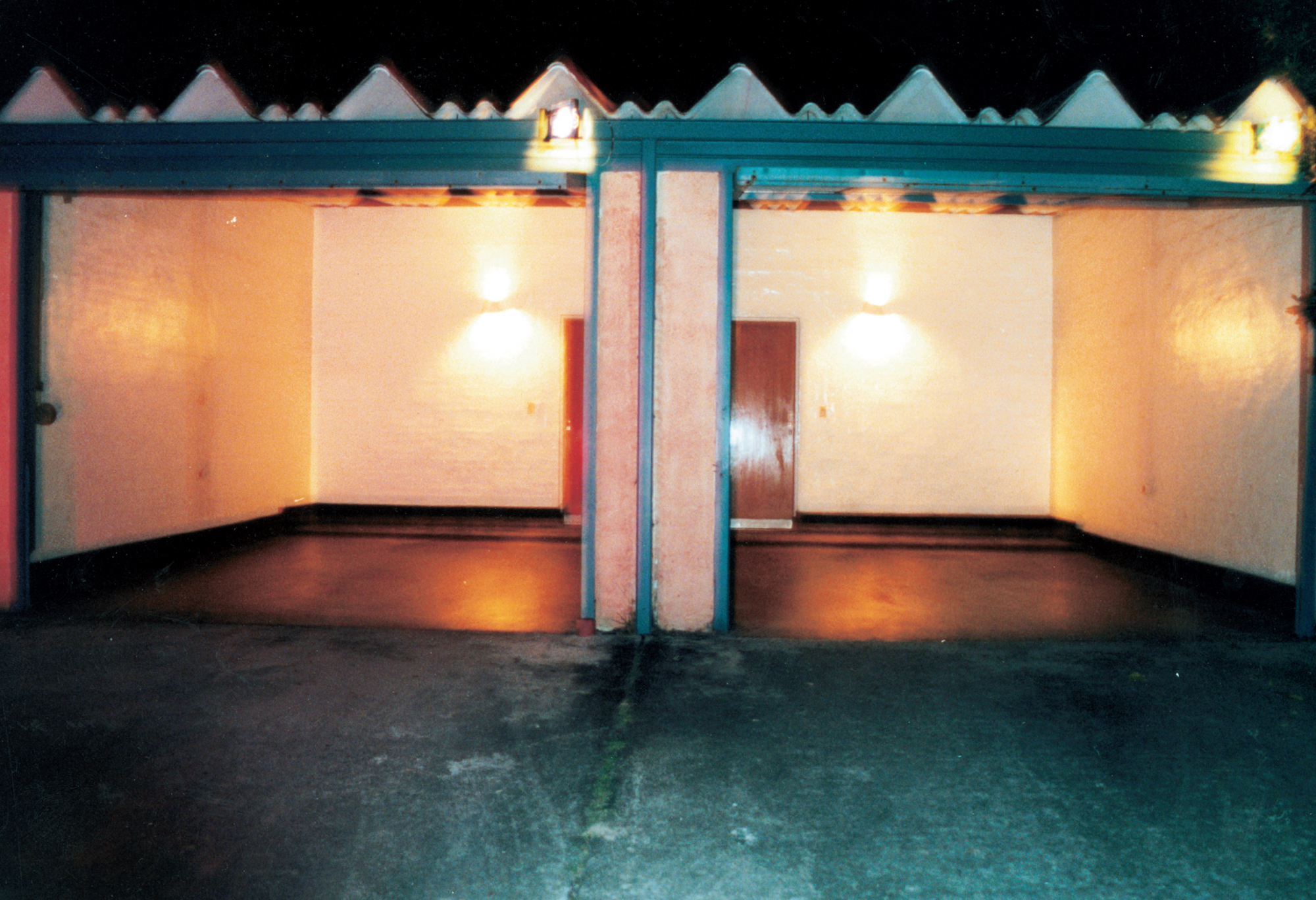 A photograph of the garage of a “telo” at night with the lights on inside.