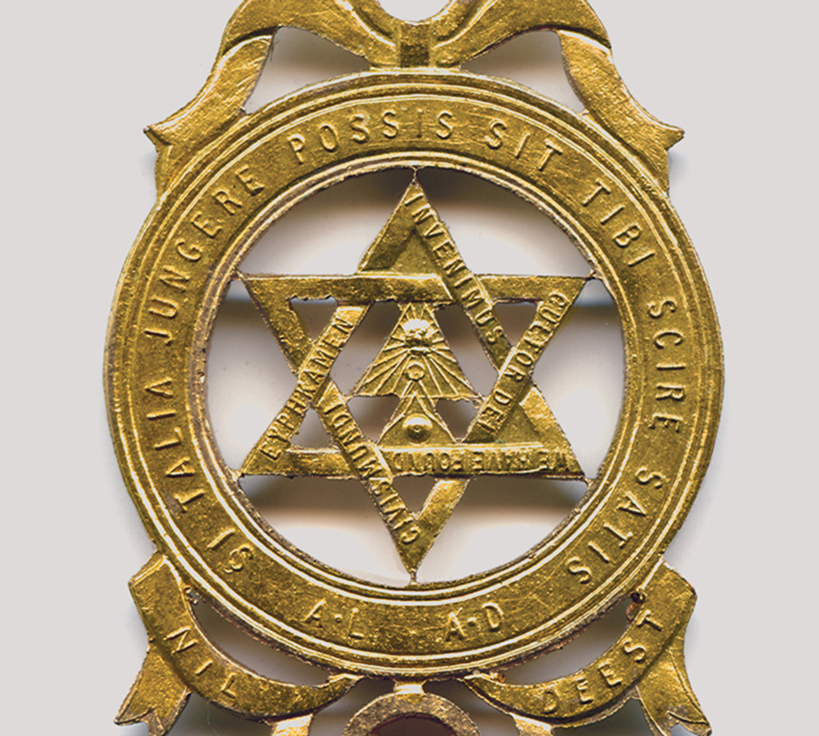 A circa nineteen fifty Royal Arch Freemason’s brass medallion depicting the form of a hexagram.