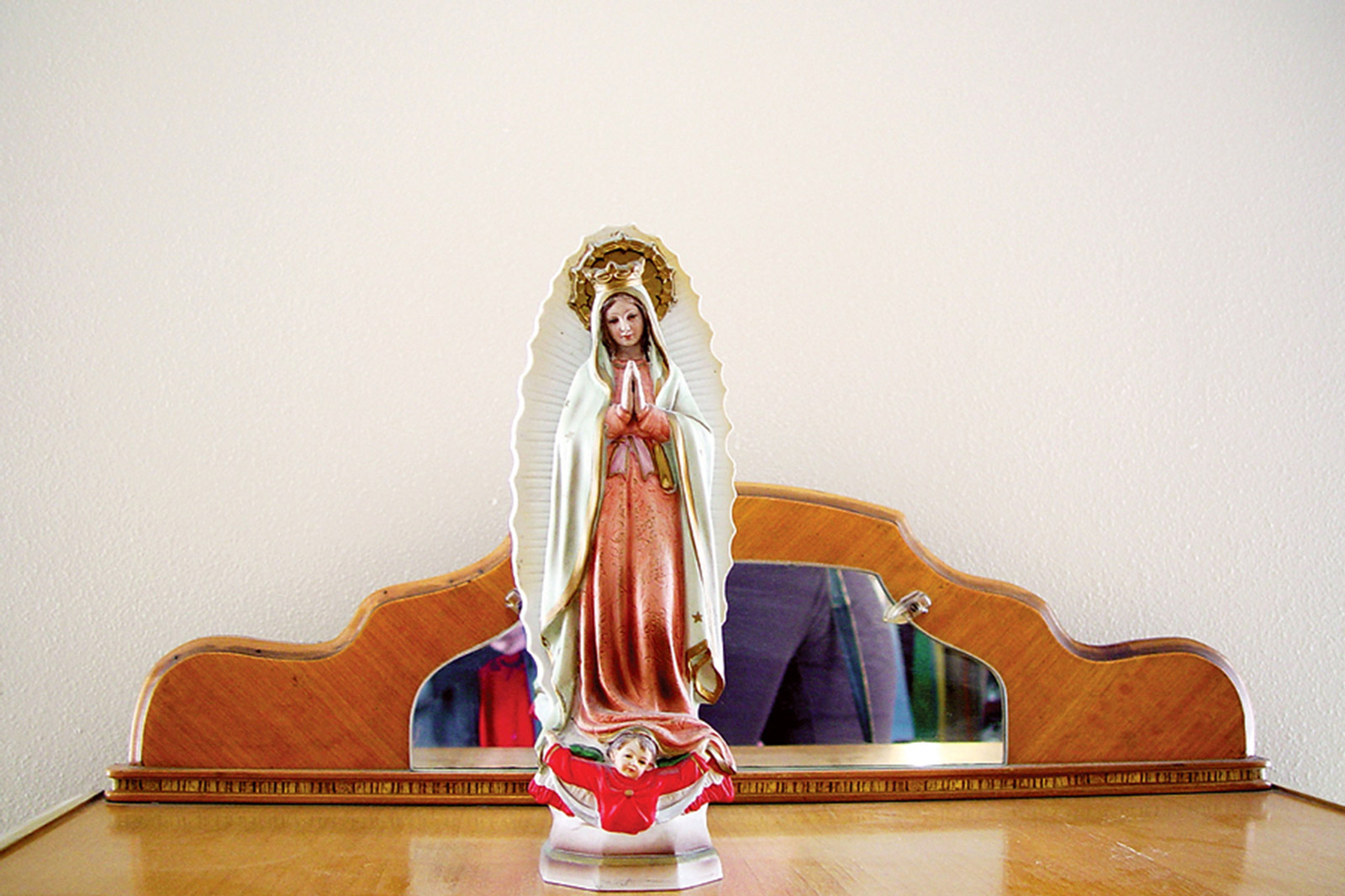 A photograph titled “Reminder to Be Kind and Thoughtful” of a religious statuette, from Casey Logan’s two thousand and seven artist project titled “Shopping in Sin.”