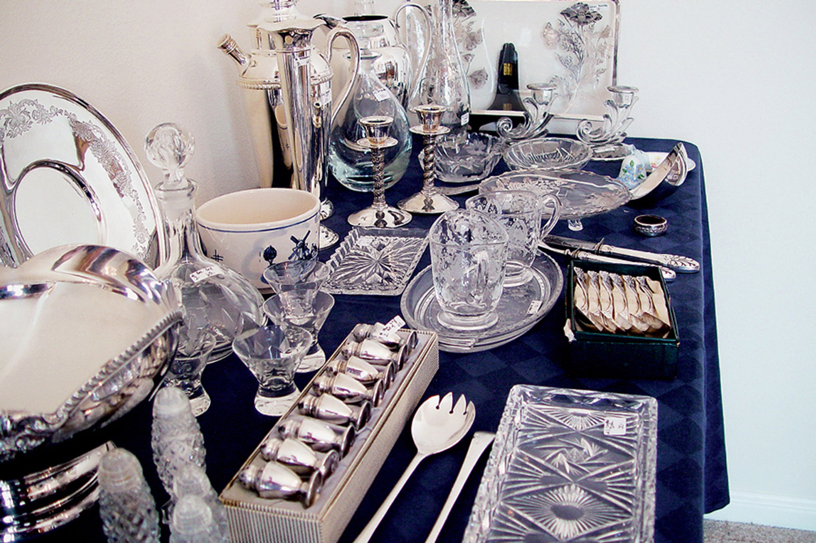 A photograph titled “Last Supper” depicting an array of tableware, from Casey Logan’s two thousand and seven artist project titled “Shopping in Sin.”