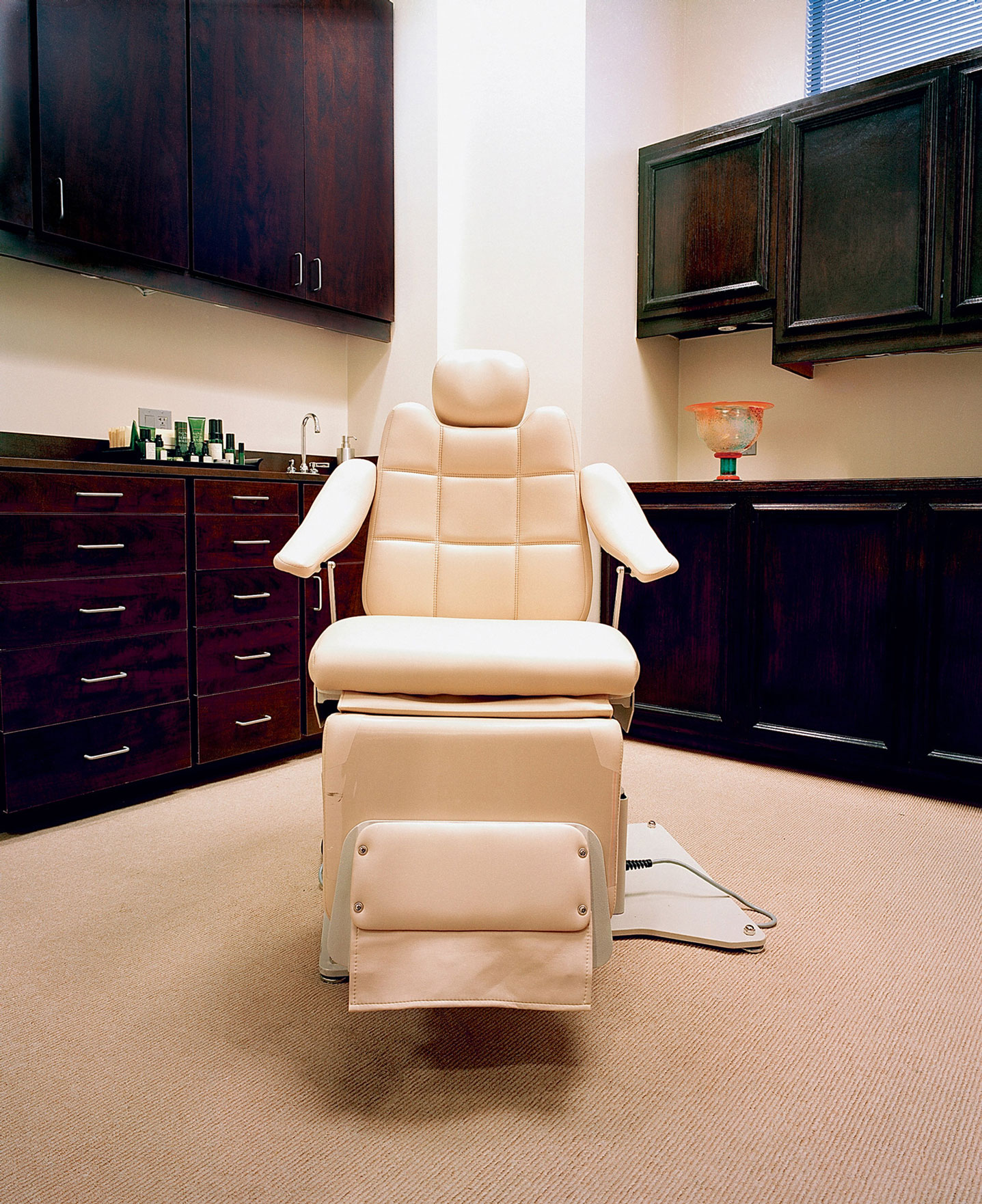 A 2008 photograph by Cara Phillips titled “Beige Construction Chair.”