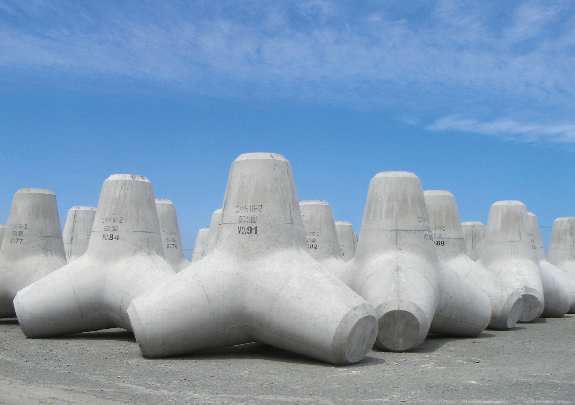 A photograph of newly manufactured tetrapods on land before being put to use.