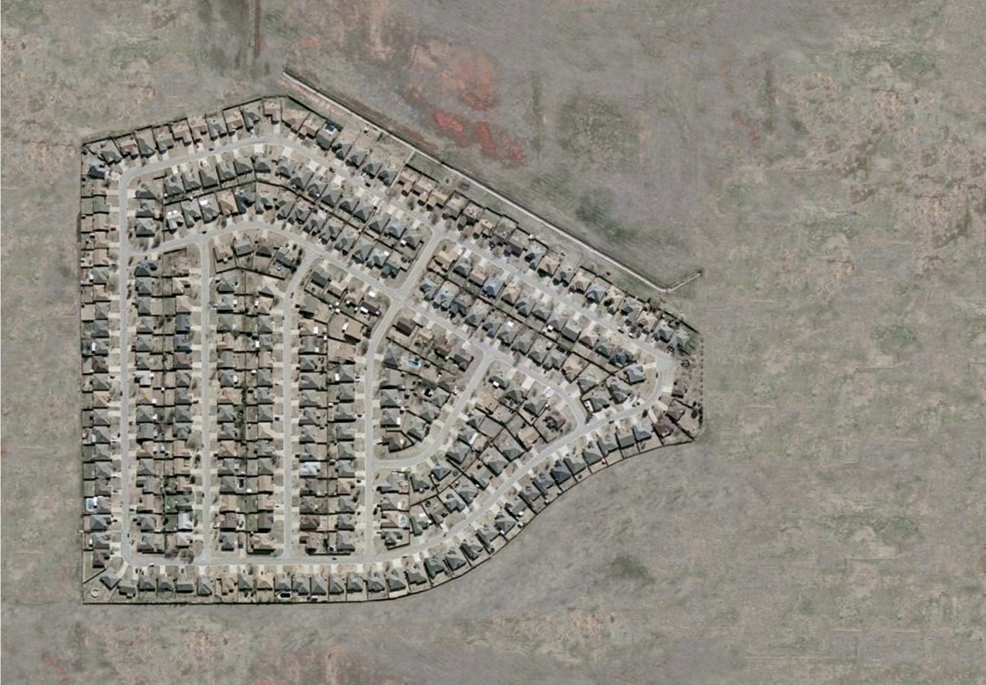 An altered aerial photograph by Jeremy Drummond of a planned housing community in Oklahoma.