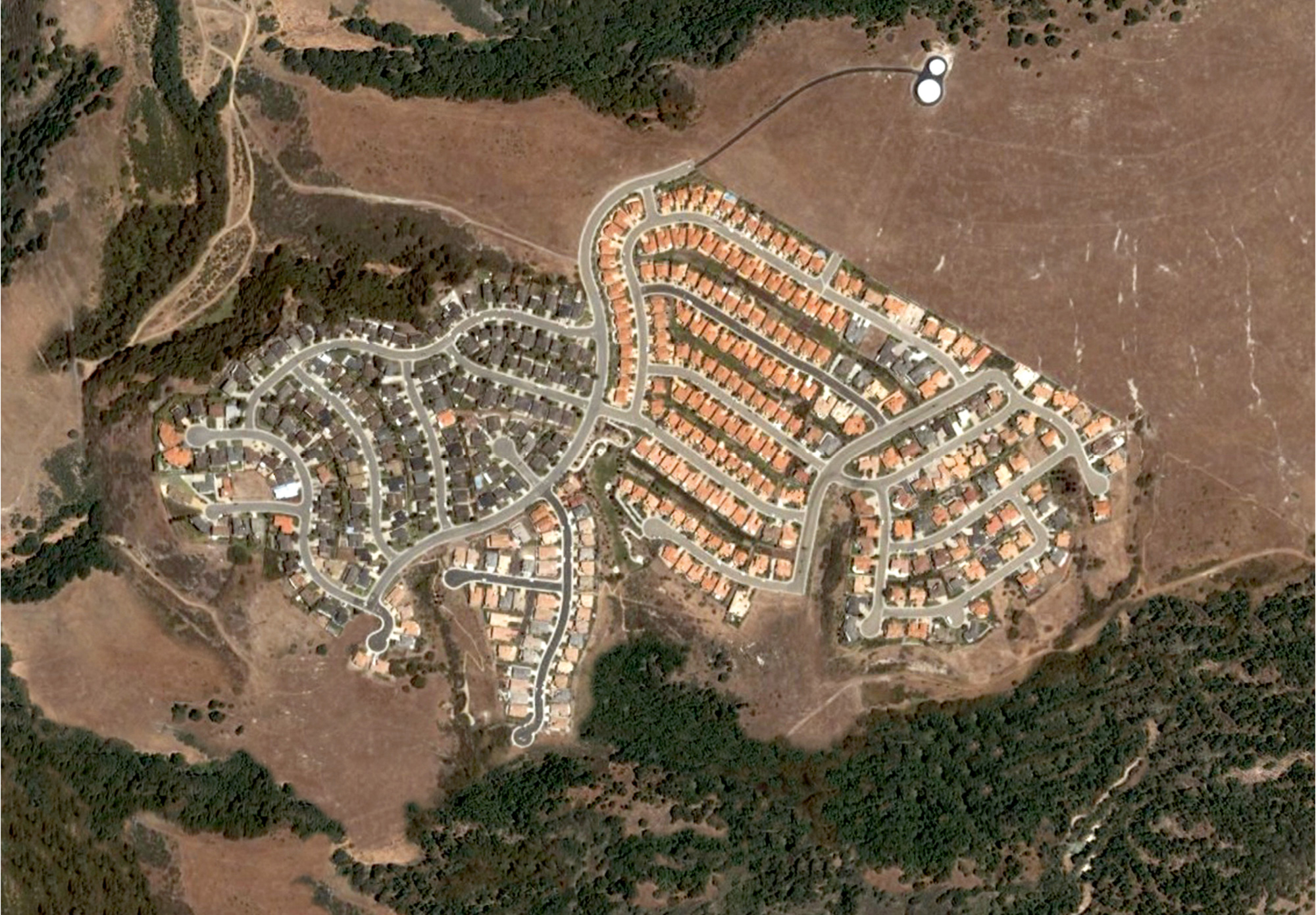 An altered aerial photograph by Jeremy Drummond of a planned housing community in California.