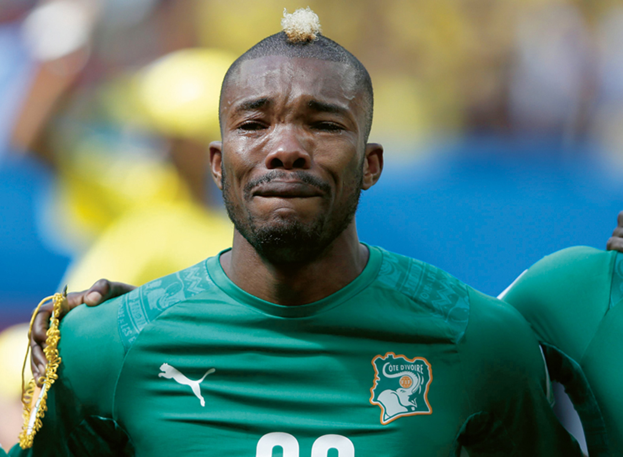 A photograph of soccer player Geoffroy Serey Die in tears.