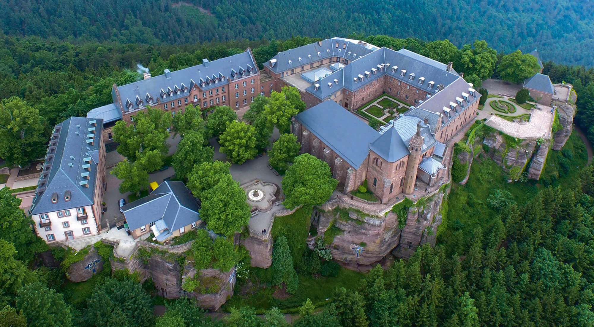 An aerial photograph of the monastery Mont Sainte-Odile, perched high in the mountains of France.