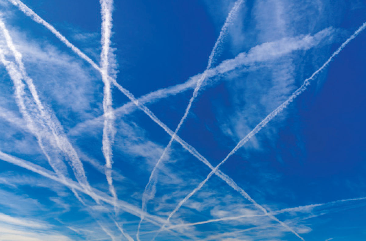 A photograph of criss-crossing trails of skywriting.