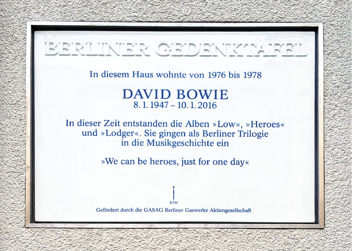 A photograph of a commemorative plaque around the corner at one fifty five Hauptstrasse, marking the building in which David Bowie lived from nineteen seventy six to nineteen seventy eight.