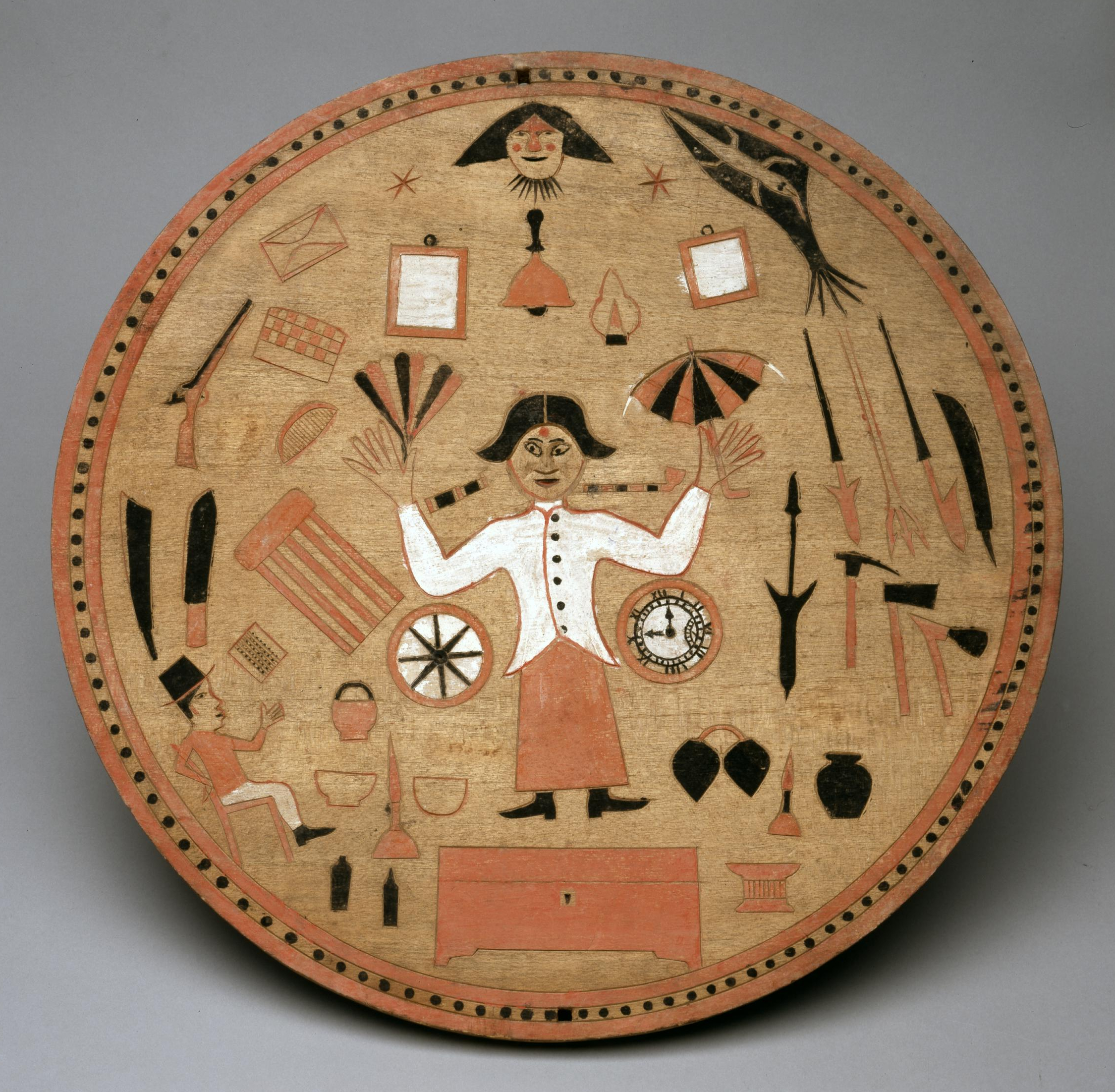 Late nineteenth-century henta—an apotropaic image from the Nicobar Islands (Indian Ocean) that would originally have been installed in a house. A figure, positioned in the center of a round, disc-like object is surrounded by native animals and indigenous objects as well as distinctly European items like the rifle, the clock, and the letter in its envelope.