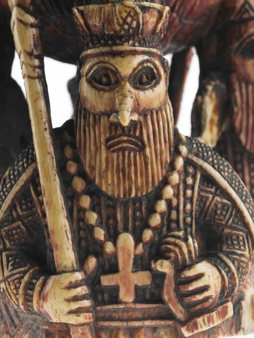 Detail from a fragment of a sixteenth-century ivory saltcellar, from the Kingdom of Benin and probably made for the export trade. It is one of the oldest artifacts included in The Savage Hits Back and features four Portuguese soldiers supporting a large bowl on their heads. It once sat on a base, which depicted the soldiers’ feet, and was topped by a lid and ship-shaped finial, but only this middle section survives. Lips—basing his analysis, as in many other instances, solely on photographic documentation—treats the saltcellar briefly in his chapter “Missionaries, Monks, and the New God,” focusing on the cross around the neck of the central man as an index of the beliefs that the Portuguese sought to impose in Benin and elsewhere. (In this context, the saltcellar’s pairing of cross and sword is significant.) Religion was at the forefront of the encounter between the Portuguese and the peoples of West Africa, and it therefore played a lead role in this and many other images of the European. The symbol of the cross was clearly familiar to the ivory carver, and yet he has carved it upside down, suggesting that the familiarity is nascent and incomplete. Courtesy National Museum of Scotland.