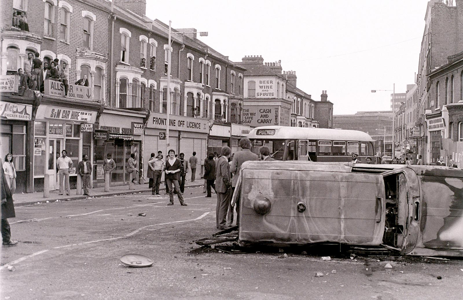 Overturned vehicle in Coldharbour Lane, Brixton, April 1981. The uprising in south London, which lasted from 10 to 12 April, resulted from the Metropolitan Police’s use of “sus” laws to stop and question some thousand Black residents of the neighborhood in the five days leading up to the unrest.