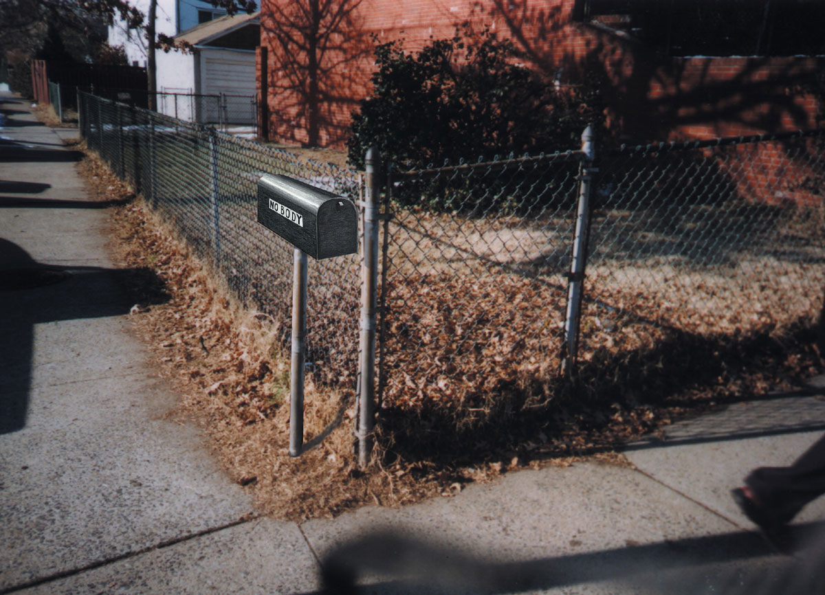 Photograph by Clara Williams of a lot with a corner fence and mail box.