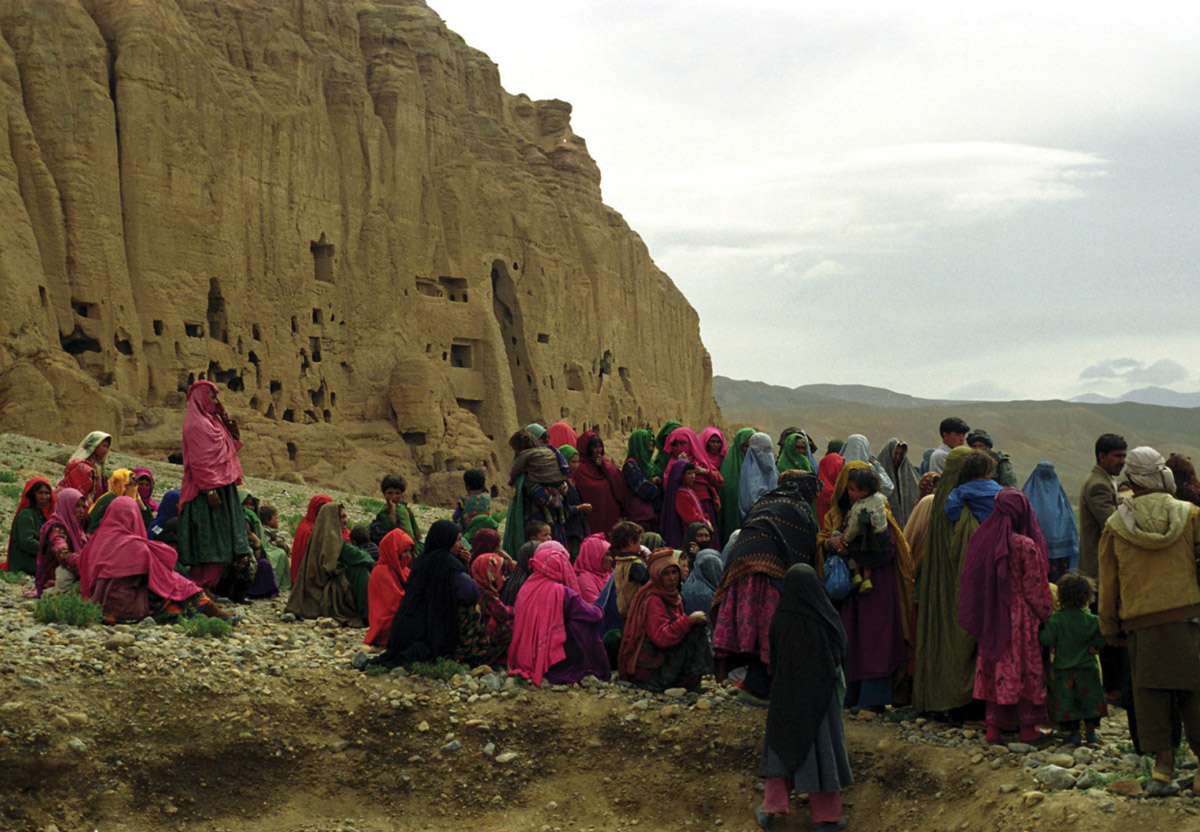 A photograph of families sitting on an outlook next to the Buddha grottoes.