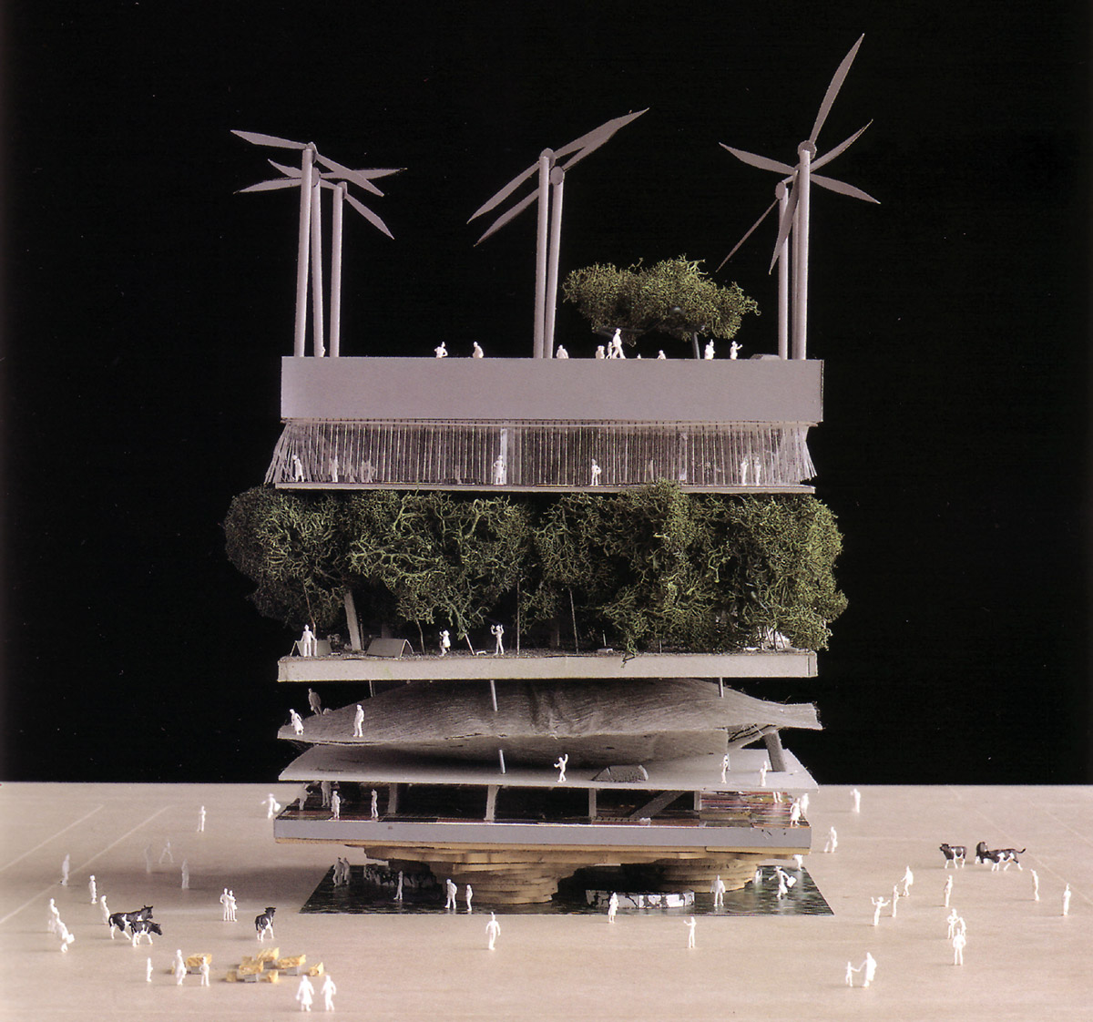 A photograph of a model from the 2000 Hanover Expo of a layered, multimedia building with wind turbines on top by MVRDV, entitled Dutch Pavilion.