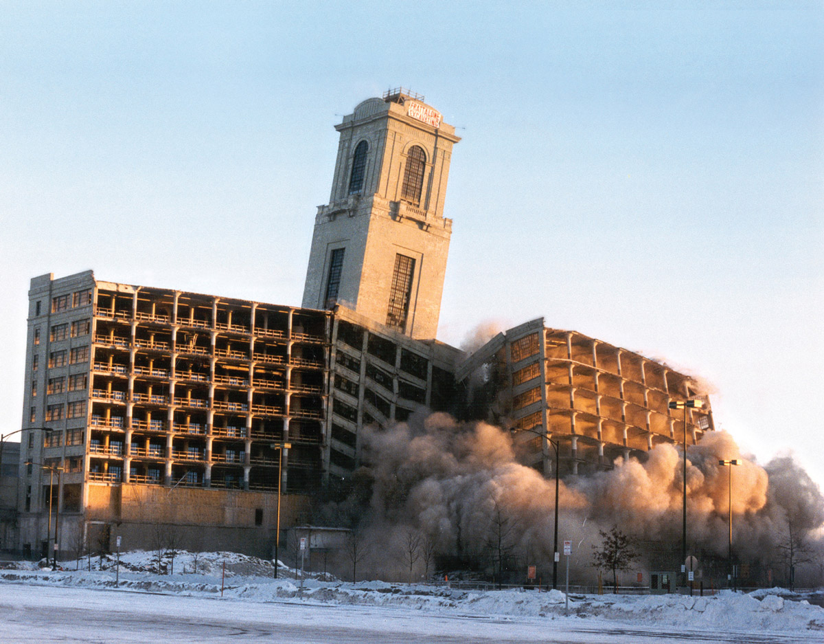 A photograph of the imploding Montgomery Ward Headquarters, St. Paul, Minnesota, 7 January 1996.