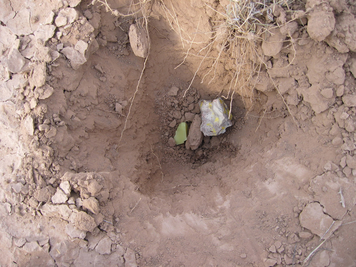 A photograph of artist Luke Murphy's block of uranium placed in a hole in Cabinetlandia.