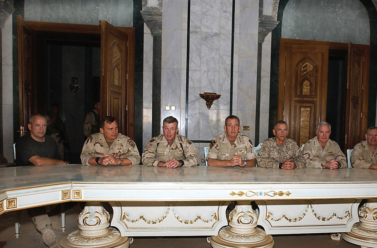 An April 2003 photograph by David K. Dismukes of American commanders gathered in one of Saddam Hussein’s palaces, the defeated party completely absent.