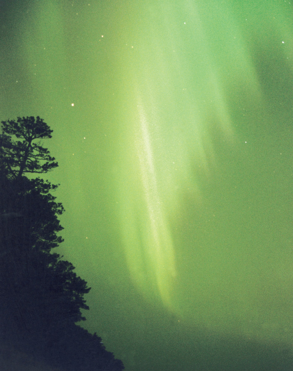 A photograph of a green aurora borealis near Marquette, Michigan, June 2003.
