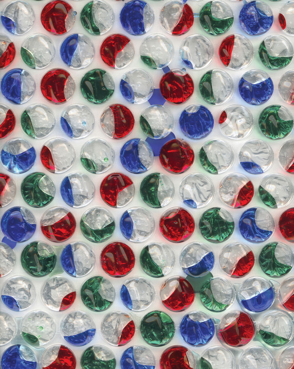 A photograph of bubble wrap colored with red, green, and blue ink.