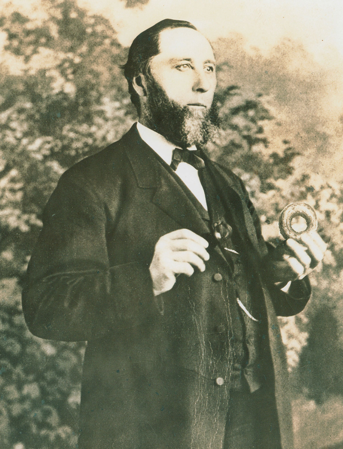 A photograph of Captain Hanson Crockett Gregory holding a doughnut.