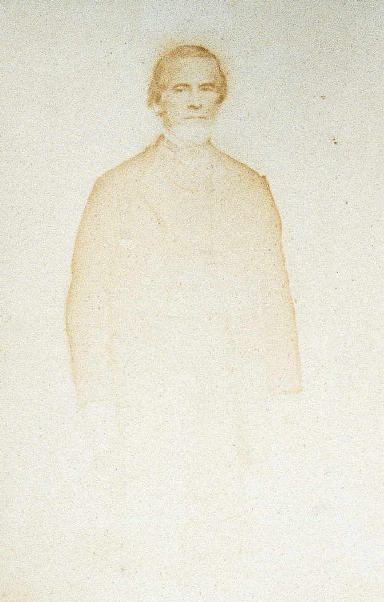 Photograph of a man fading at waist.