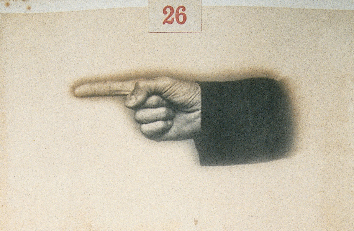 Photograph of a hand pointing left.