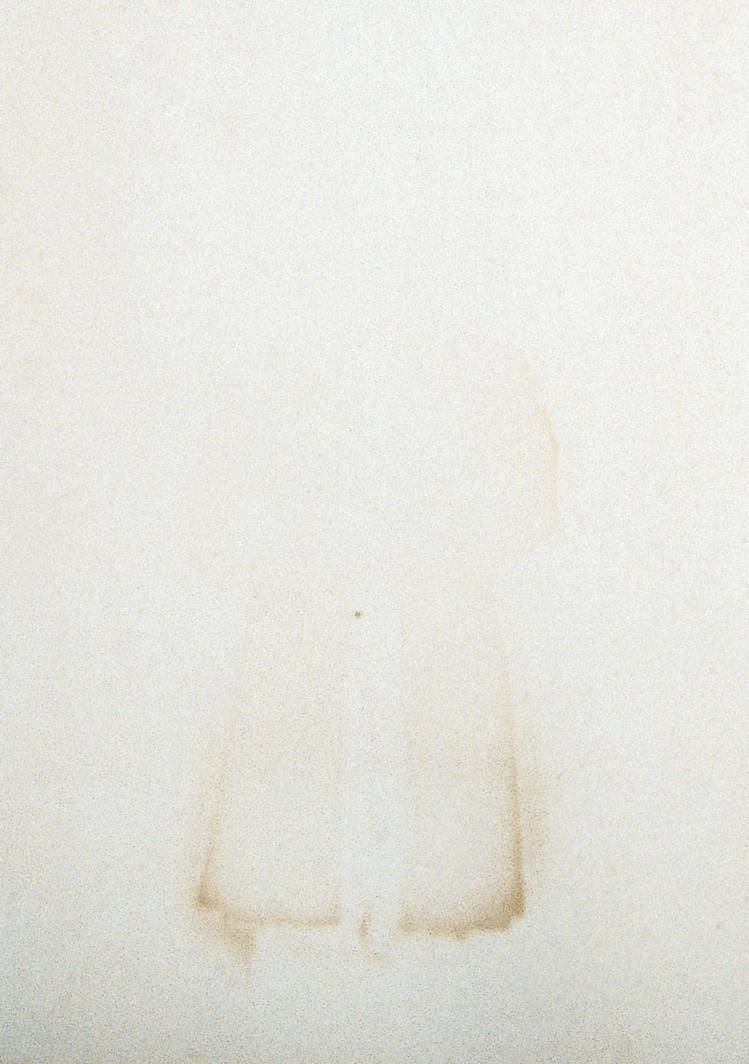 Photograph of a man almost entirely faded from the waist up.