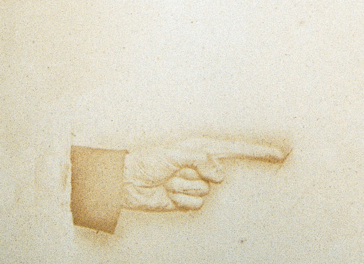 Photograph of a hand pointing right.