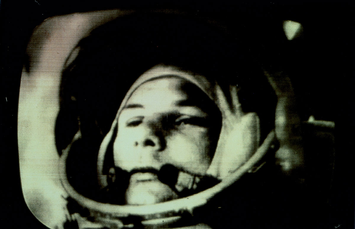 A close-up of Yuri Gagarin's face in his astronaut helmet from televised footage of his epochal voyage on 12 April 1961.