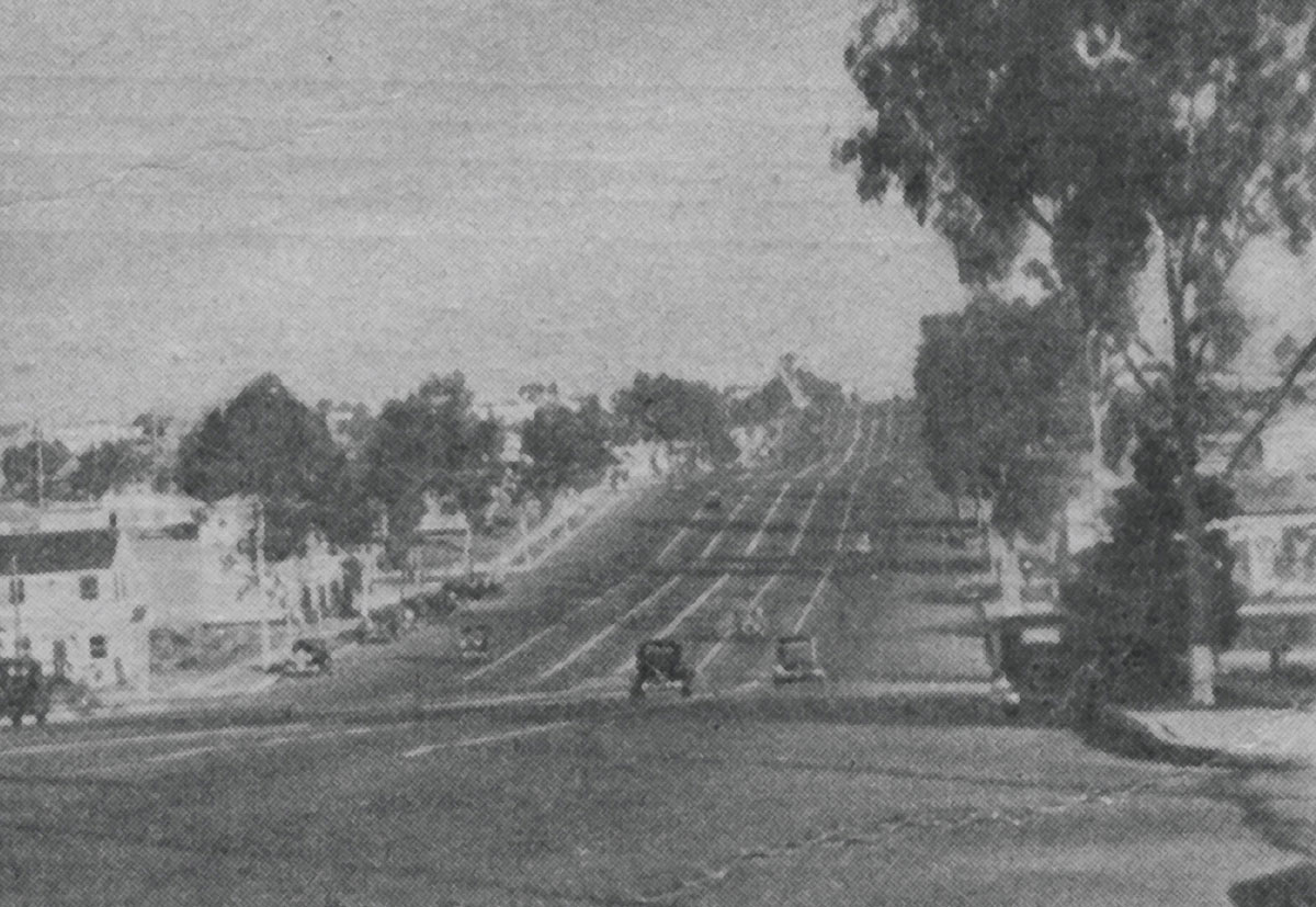 Black-and-white photograph of a multi-laned road.