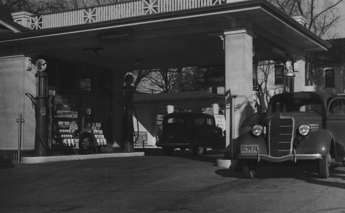 Black-and-white photograph of a gas station.