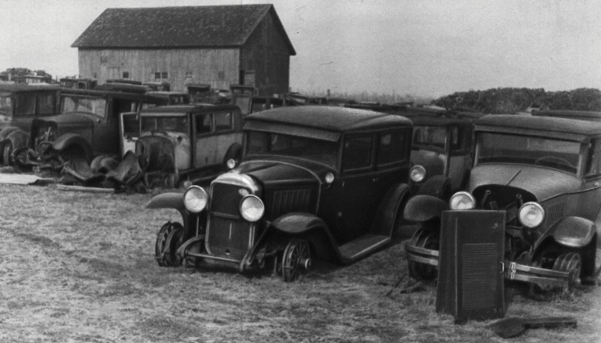 Black-and-white photograph of an automobile cemetery.