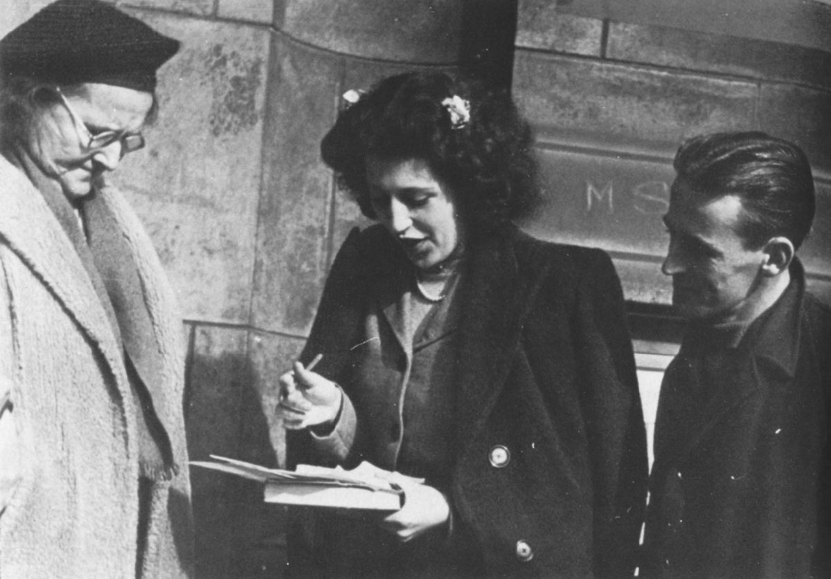 A photograph of Mass-Observers interviewing people waiting in line for the 1946 “Britain Can Make It” exhibition at the Victoria and Albert Museum.