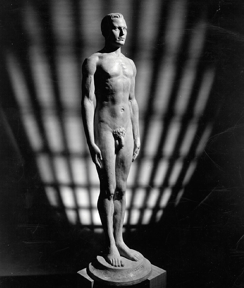 A photograph of a 1943 white alabaster statue entitled “Normman,” based on the measurements of 15,000 men.