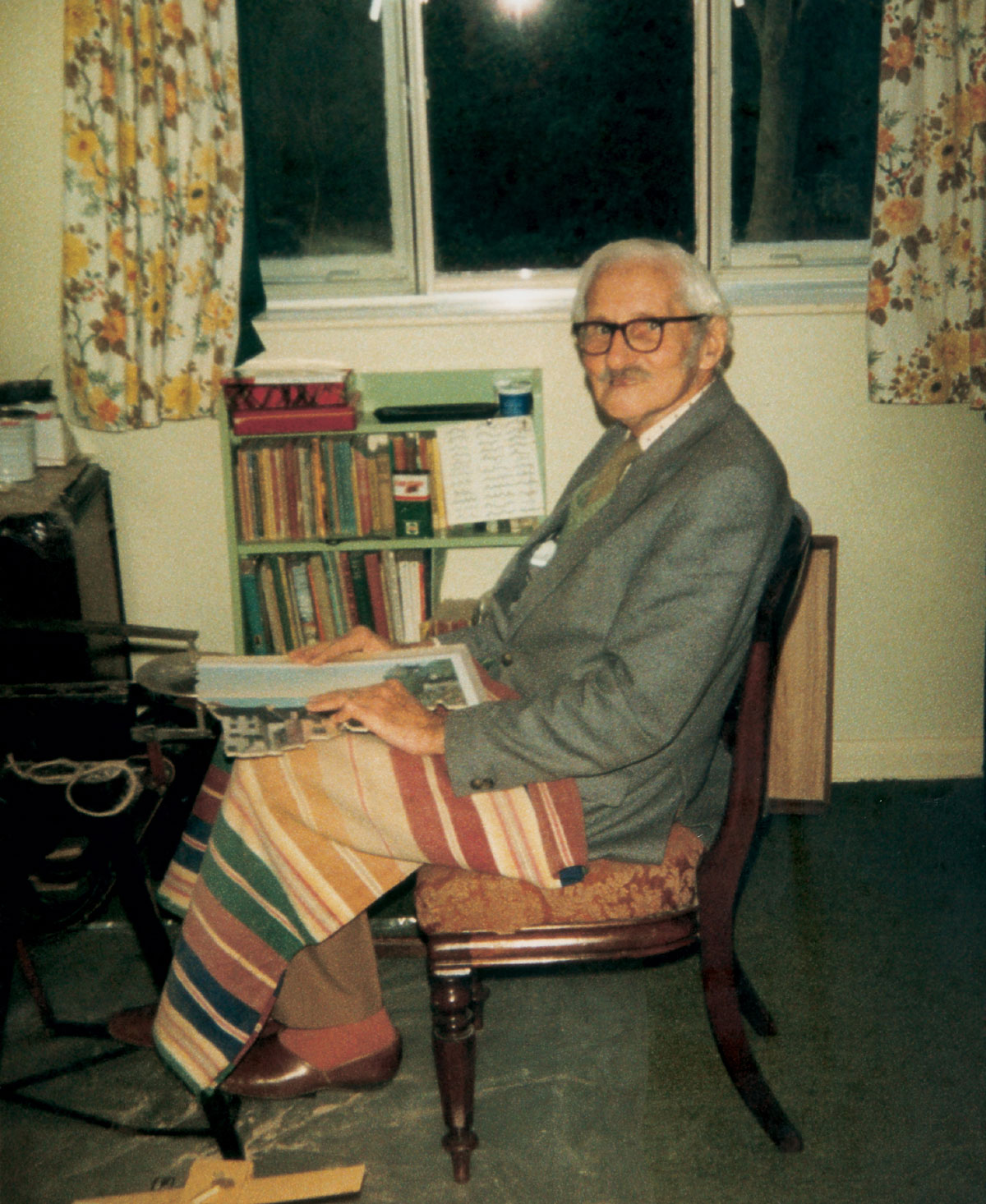 A photograph of puzzlemaker Dick Sawbridge holding a semi-cut puzzle.