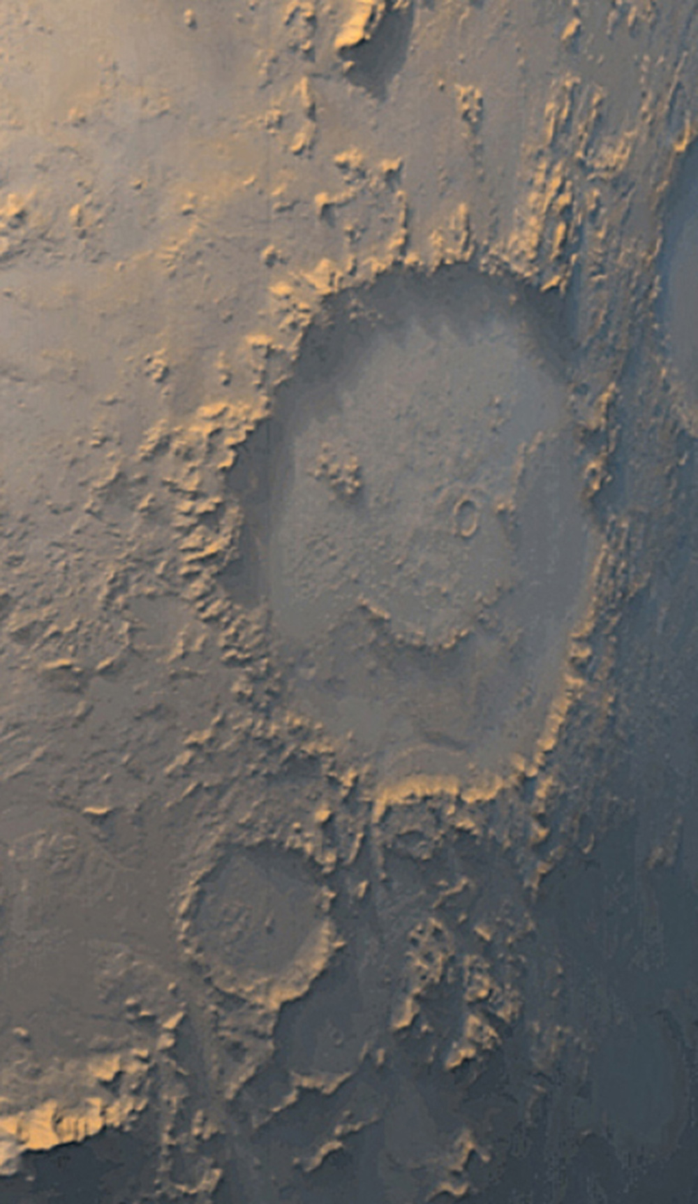 A photograph of Mars’s smiley face–shaped Galle Crater.