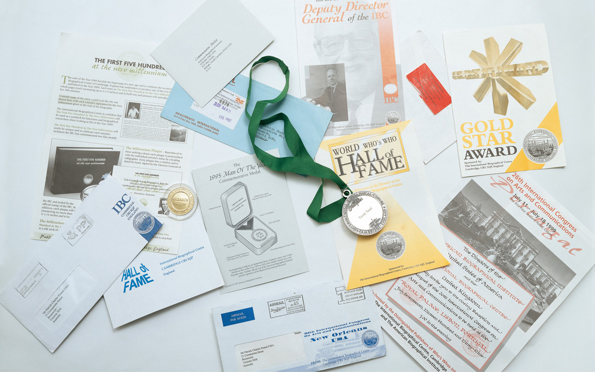 A photograph of certificates, medals, and various awards.