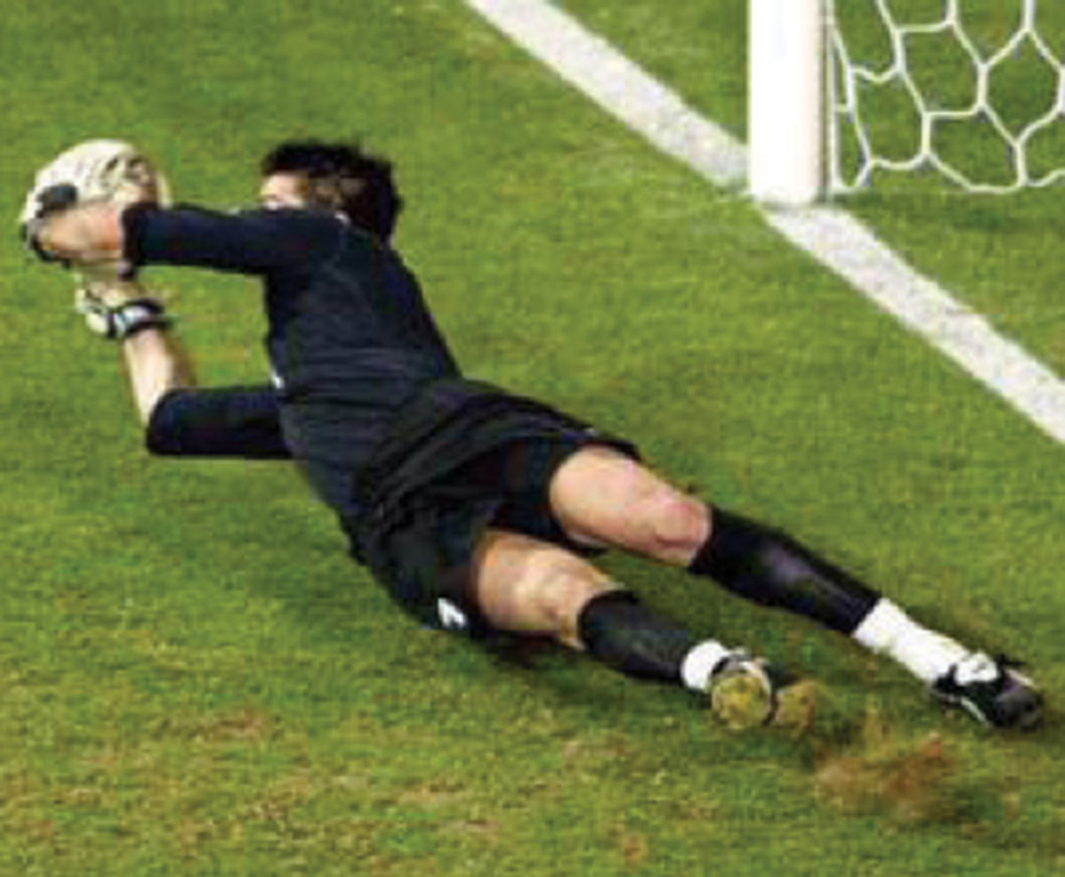 A photograph of Buffon saving a goal.
