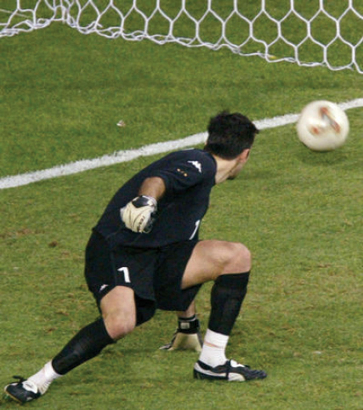 A photograph of Buffon saving a goal.