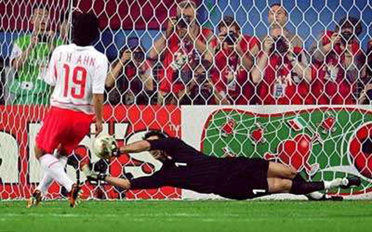 A photograph of Buffon saving a goal.