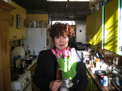 A photograph of Maggie arranging the flowers in a vase.