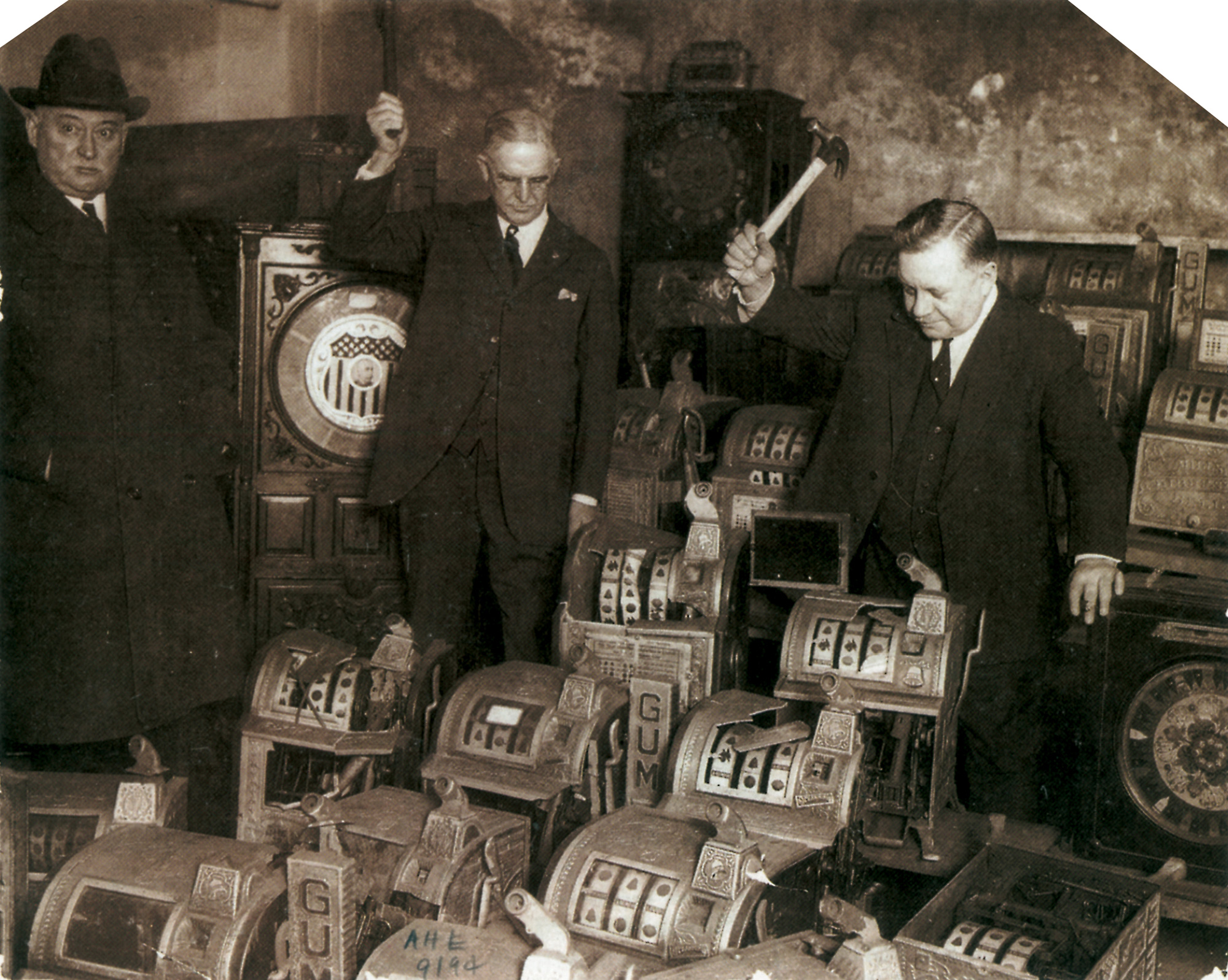 A circa 1930s photograph of illegal slot machines being destroyed by Chicago law enforcement.