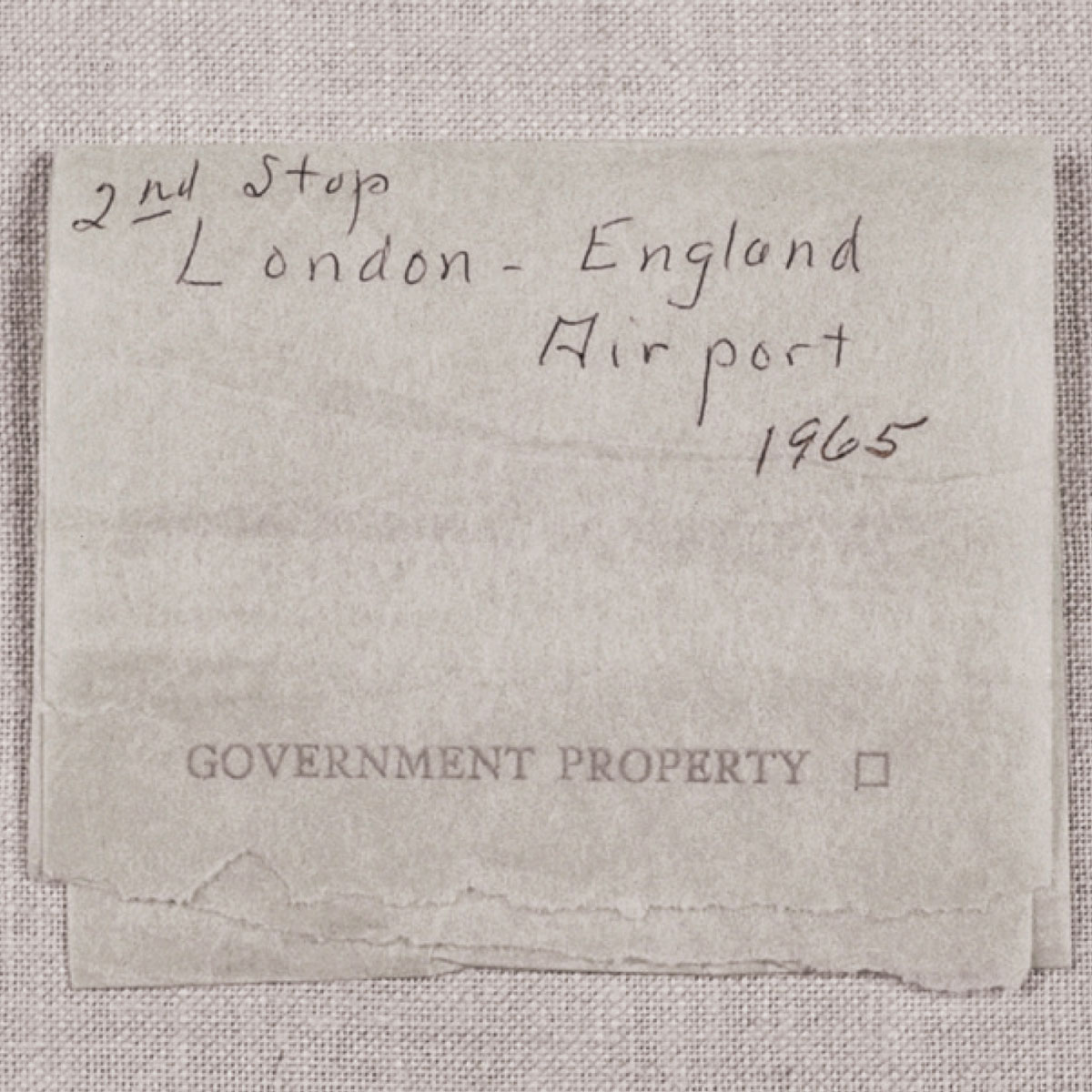 A piece of toilet paper annotated with the phrase: “2nd Stop London - England Airport 1965.”